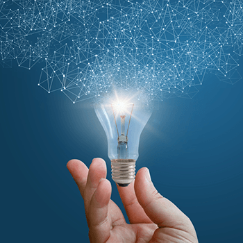 Composite image of a person holding a lightbulb to symbolize new ideas.